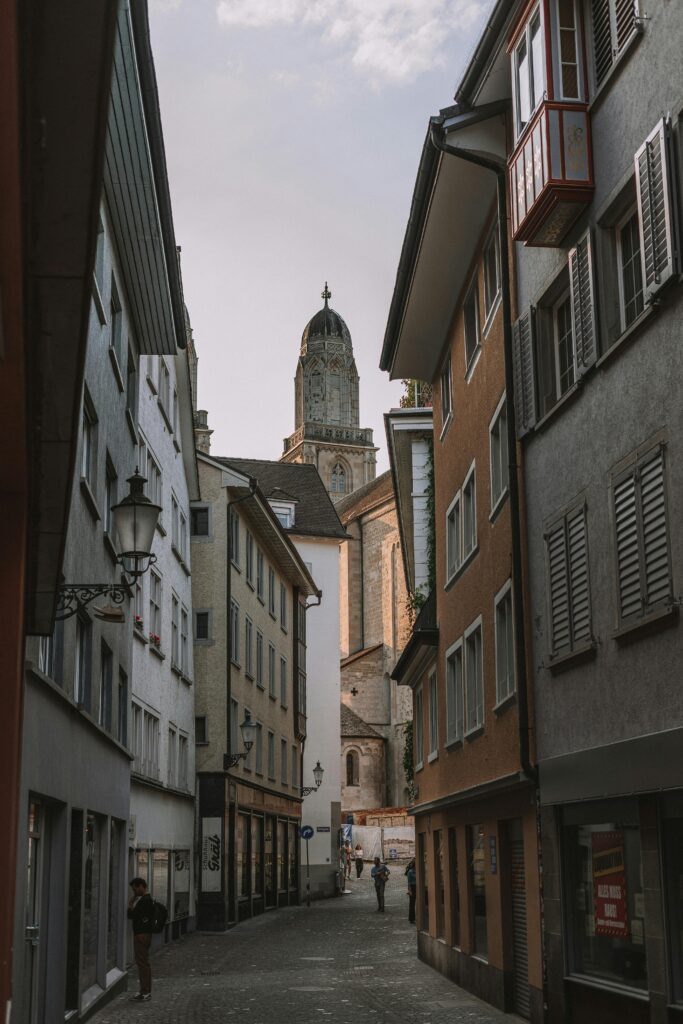 Romantic view of Zurich's narrow alleyway leading to the iconic Grossmünster Cathedral, Switzerland.